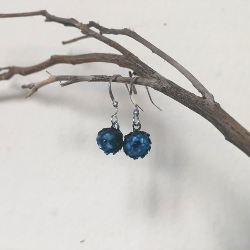 Blue margaret earrings mounted on a simple wire hook