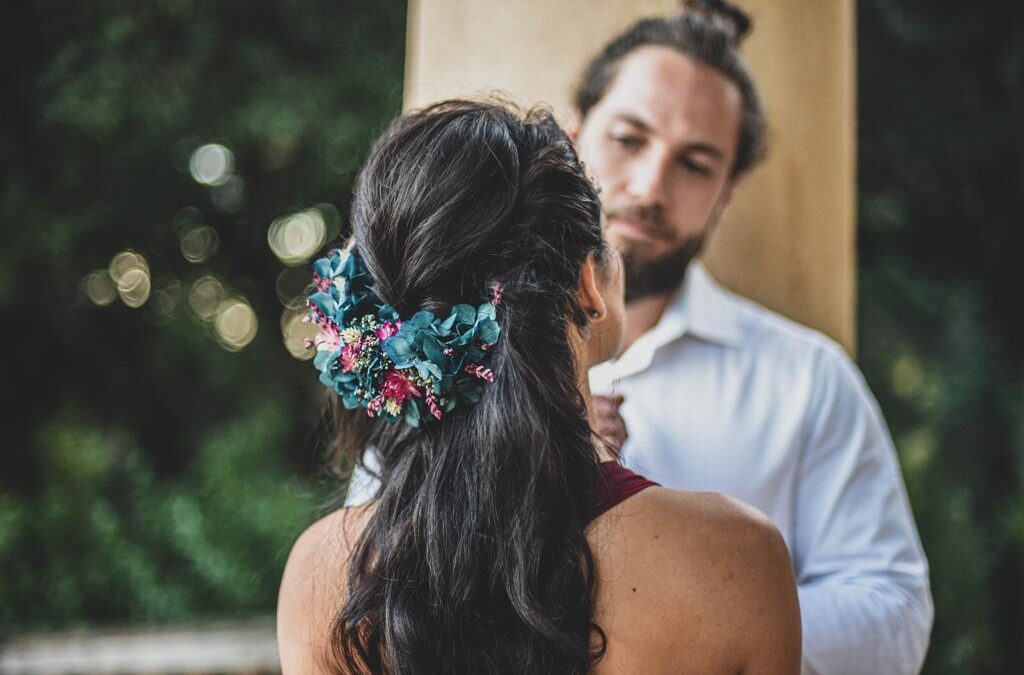 The detail of the bride wearing a blue hydrangea flower headdress