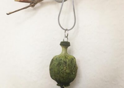 Green poppy head necklace.